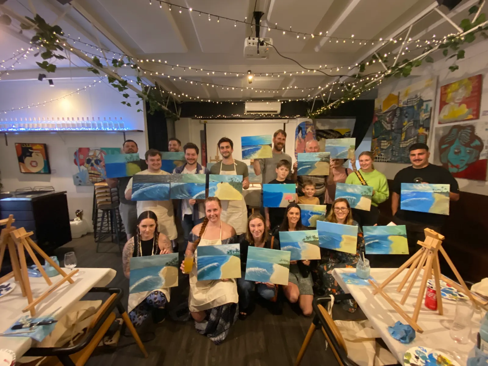 Guests painting together at a Sip & Paint event